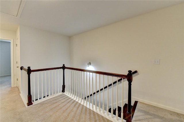 stairway featuring carpet and baseboards