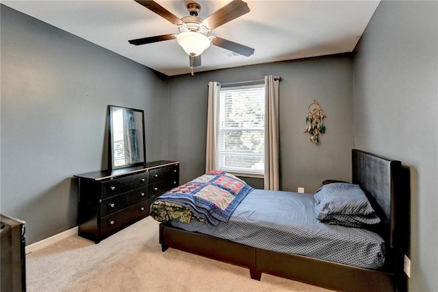 bedroom featuring light carpet, ceiling fan, and baseboards