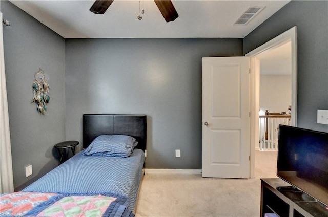 bedroom featuring light carpet, ceiling fan, visible vents, and baseboards