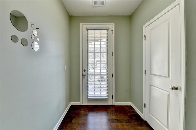 entryway featuring baseboards, dark wood-style flooring, visible vents, and a healthy amount of sunlight