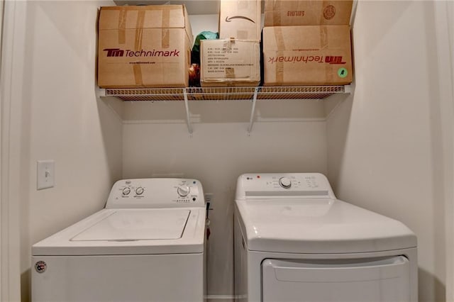 clothes washing area with laundry area and independent washer and dryer