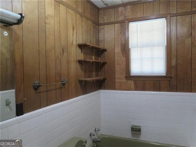 bathroom with shower / bathing tub combination and wooden walls