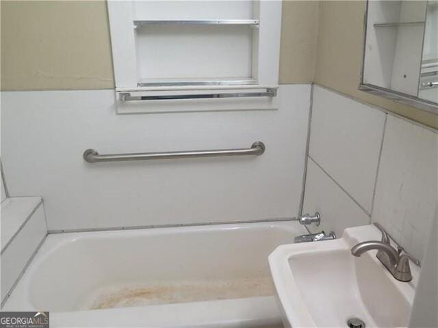 bathroom with tile walls and sink