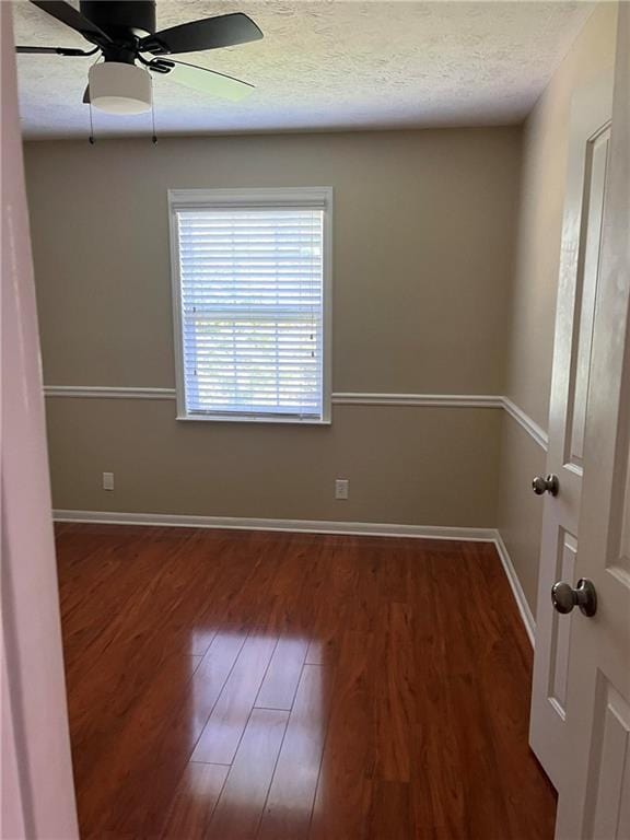 1007 Wayne Dr, Snellville, GA 30078 - spare room featuring wood finished floors, baseboards, a ceiling fan, and a textured ceiling