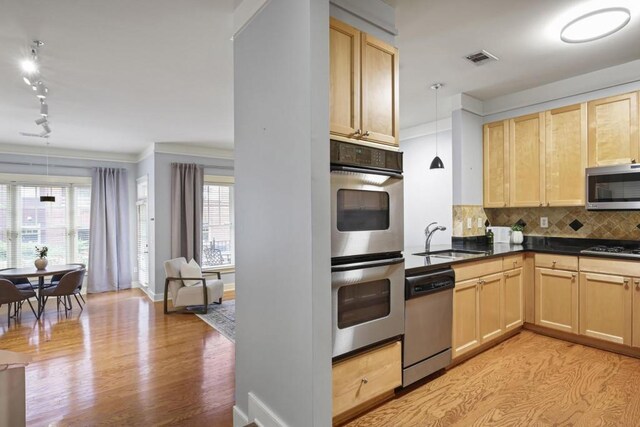 273 12th St NE Unit 421, Atlanta, GA 30309 - kitchen with light brown cabinetry, light wood finished floors, a sink, rail lighting, and stainless steel appliances