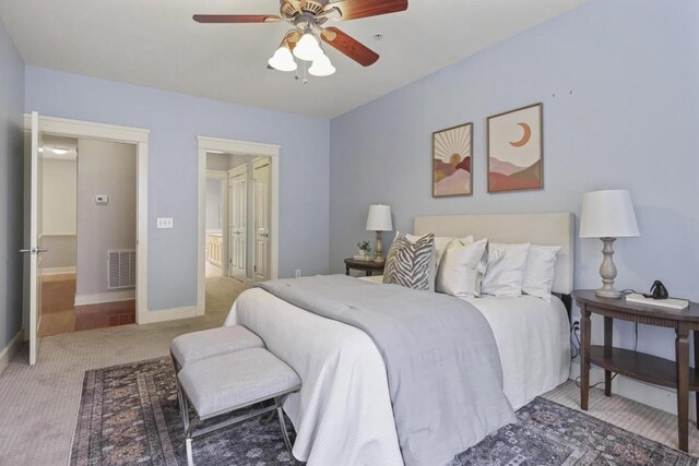 273 12th St NE Unit 421, Atlanta, GA 30309 - carpeted bedroom with ceiling fan, connected bathroom, baseboards, and visible vents