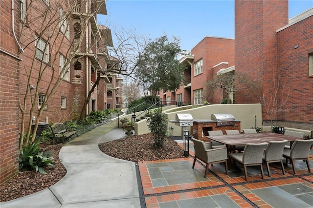 273 12th St NE Unit 421, Atlanta, GA 30309 - view of patio / terrace with grilling area, an outdoor kitchen, outdoor dining space, and central AC
