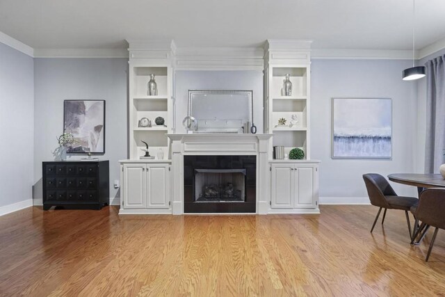 273 12th St NE Unit 421, Atlanta, GA 30309 - living area with light wood-type flooring, built in features, baseboards, and ornamental molding