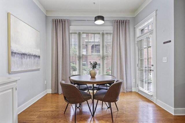 273 12th St NE Unit 421, Atlanta, GA 30309 - dining area featuring baseboards, light wood-style flooring, and crown molding
