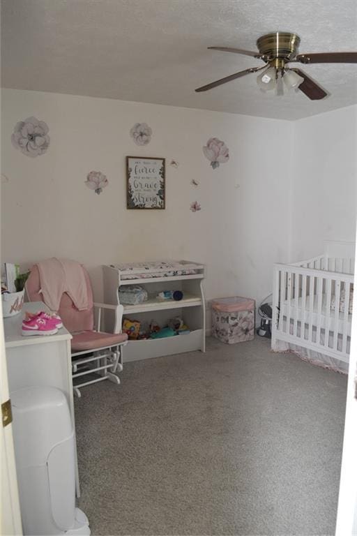 1218 Matt Moore Ct, Lithia Springs, GA 30122 - carpeted bedroom featuring a ceiling fan and a crib