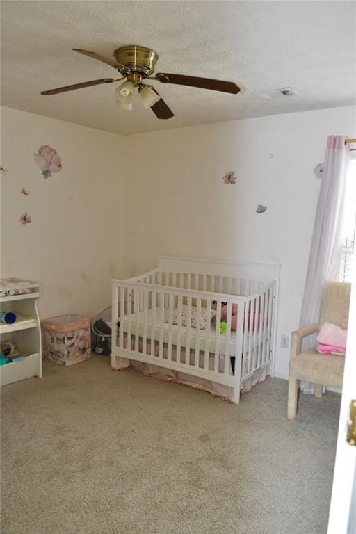 1218 Matt Moore Ct, Lithia Springs, GA 30122 - bedroom featuring carpet floors, a ceiling fan, visible vents, and a crib