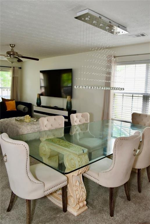 1218 Matt Moore Ct, Lithia Springs, GA 30122 - dining area featuring carpet, a ceiling fan, and a textured ceiling