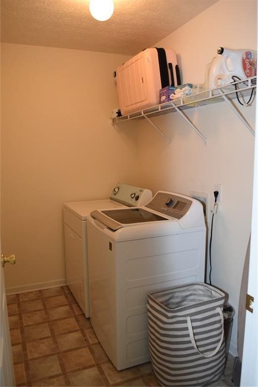 1218 Matt Moore Ct, Lithia Springs, GA 30122 - washroom featuring baseboards, laundry area, washing machine and dryer, and a textured ceiling