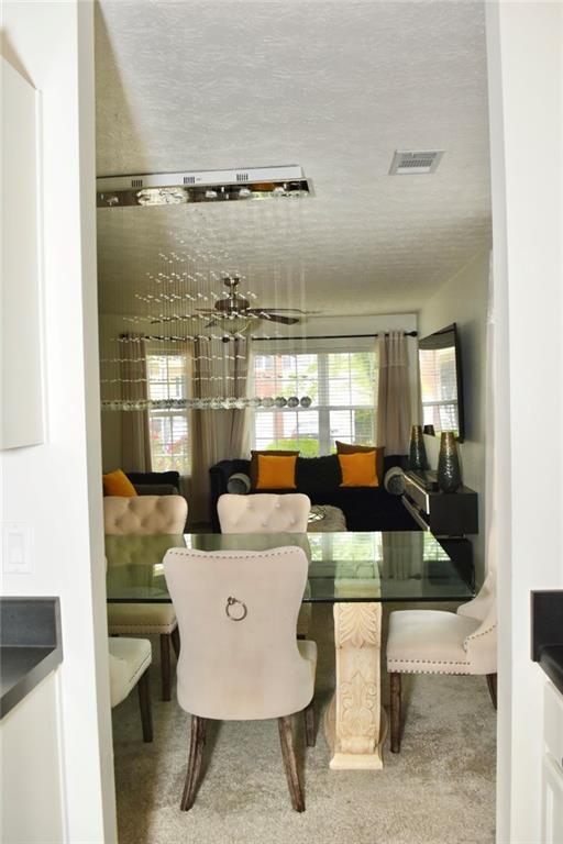 1218 Matt Moore Ct, Lithia Springs, GA 30122 - dining space featuring visible vents and a textured ceiling