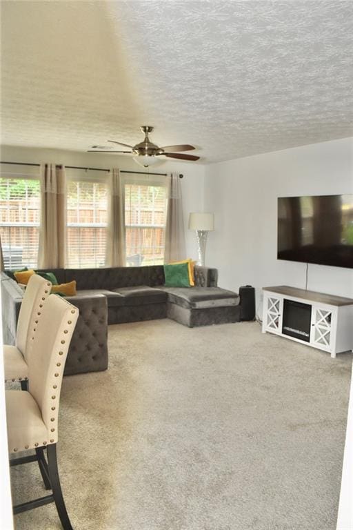 1218 Matt Moore Ct, Lithia Springs, GA 30122 - living room with carpet floors, ceiling fan, and a textured ceiling