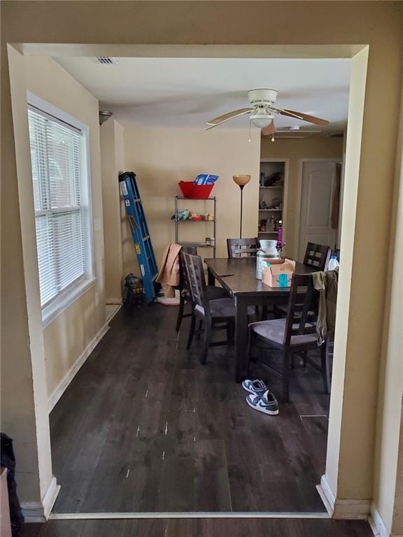 867 Commodore Dr NW, Atlanta, GA 30318 - dining room with baseboards, a ceiling fan, wood finished floors, and visible vents