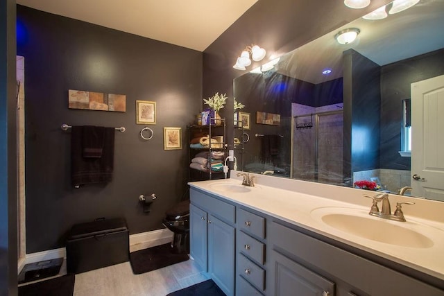 bathroom featuring vanity, walk in shower, and toilet