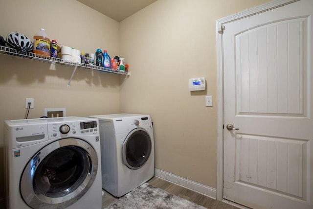 washroom with separate washer and dryer and light hardwood / wood-style floors