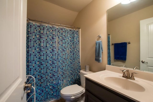 bathroom featuring vanity, a shower with shower curtain, and toilet