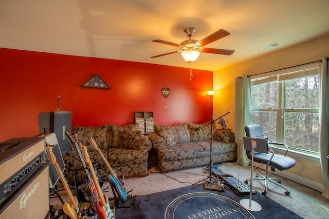 carpeted living room with ceiling fan