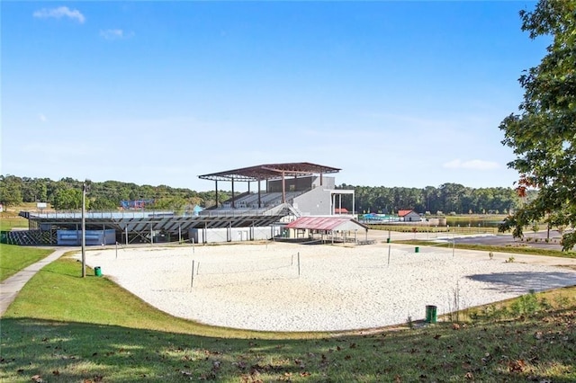 view of property's community with a yard and volleyball court