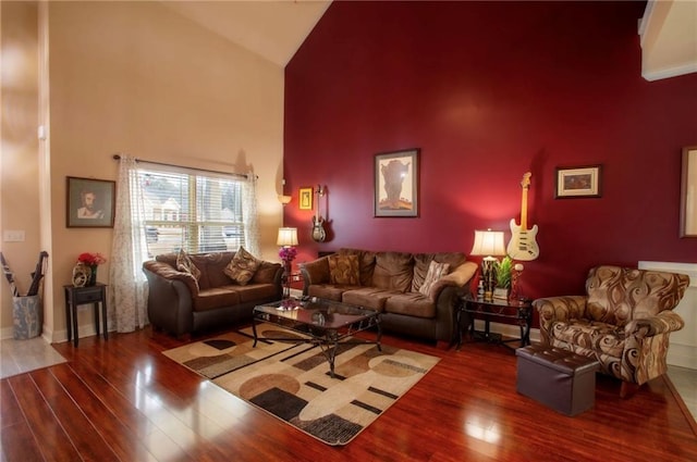 living room with hardwood / wood-style flooring and high vaulted ceiling