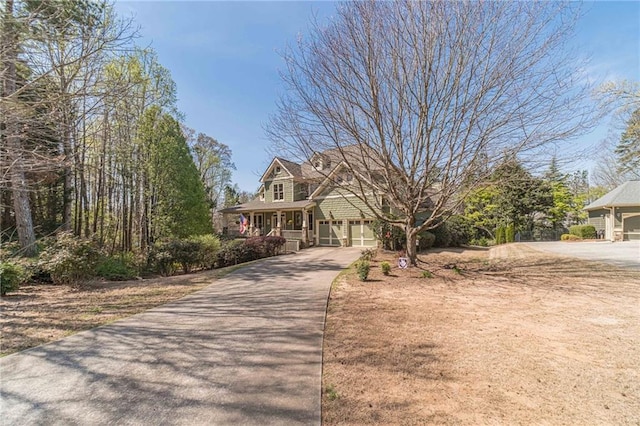 3828 Morning Meadow Ln, Buford, GA 30519 - view of front of property featuring driveway, a garage, and a porch