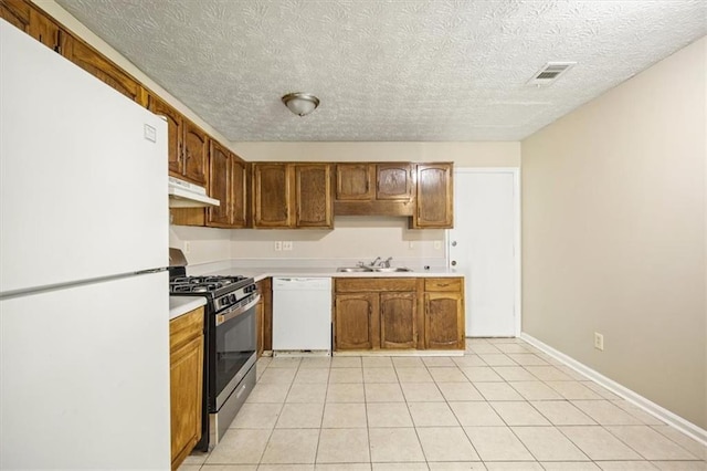 5426 Martins Crossing Rd, Stone Mountain, GA 30088 - kitchen featuring white appliances, under cabinet range hood, light countertops, brown cabinetry, and light tile patterned floors