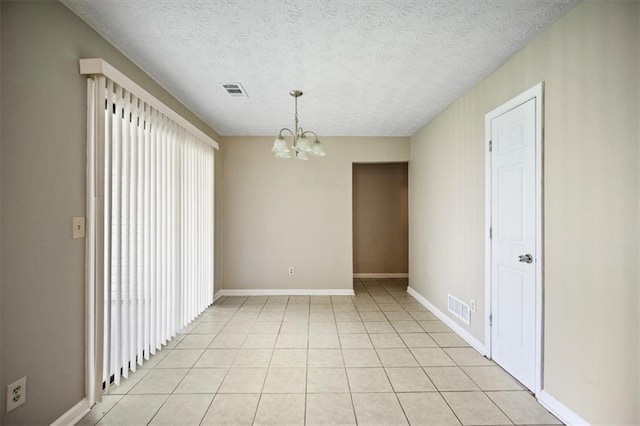 5426 Martins Crossing Rd, Stone Mountain, GA 30088 - unfurnished room featuring a chandelier, light tile patterned floors, and a textured ceiling