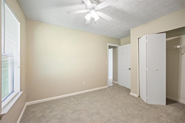 5426 Martins Crossing Rd, Stone Mountain, GA 30088 - unfurnished bedroom with a textured ceiling, carpet flooring, a closet, and ceiling fan