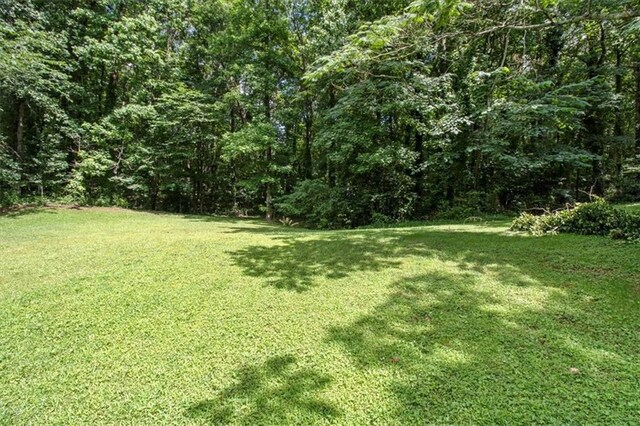 5426 Martins Crossing Rd, Stone Mountain, GA 30088 - view of grassy yard with a view of trees