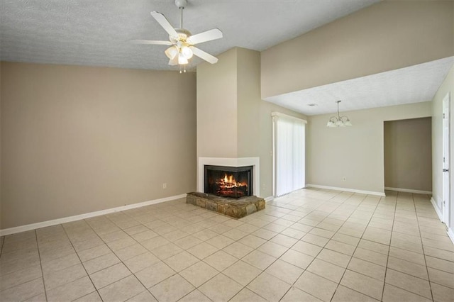 5426 Martins Crossing Rd, Stone Mountain, GA 30088 - unfurnished living room featuring a multi sided fireplace, light tile patterned flooring, a chandelier, ceiling fan, and a textured ceiling