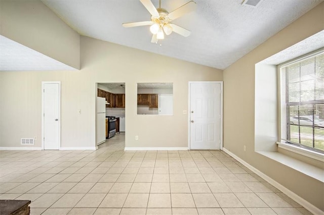 5426 Martins Crossing Rd, Stone Mountain, GA 30088 - unfurnished living room with lofted ceiling, a ceiling fan, plenty of natural light, and light tile patterned flooring
