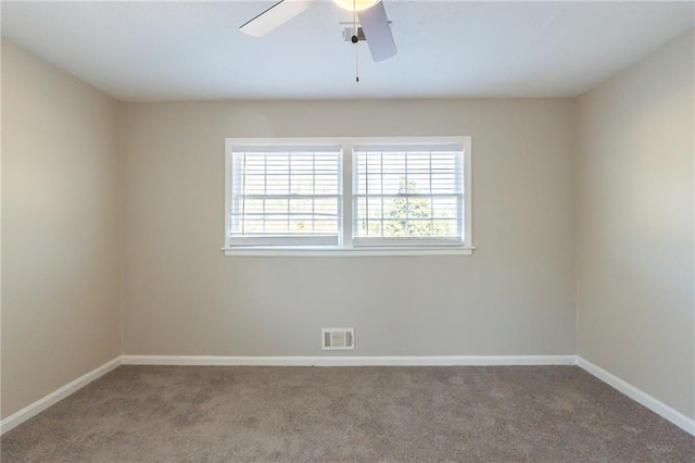 carpeted spare room with ceiling fan