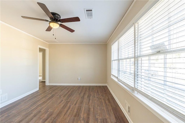 empty room with ceiling fan, ornamental molding, and dark wood-type flooring