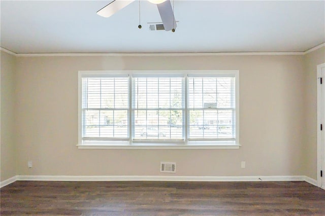 spare room featuring ceiling fan, ornamental molding, and dark wood-type flooring