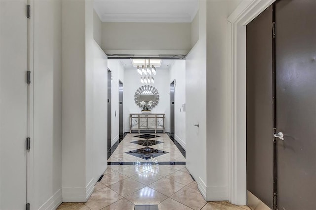 corridor featuring light tile patterned floors, baseboards, ornamental molding, and a notable chandelier