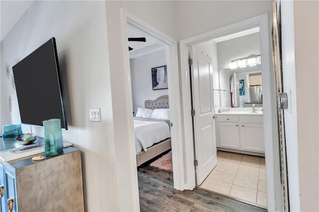 ensuite bathroom with wood finished floors, vanity, and ensuite bathroom