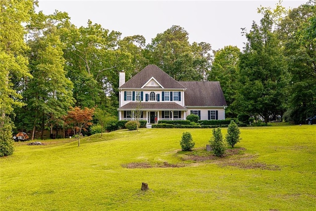 8601 Flint Hill Rd, Douglasville, GA 30135 - colonial inspired home with covered porch, a chimney, a front lawn, and view of scattered trees