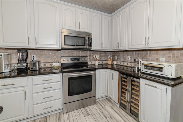 8601 Flint Hill Rd, Douglasville, GA 30135 - kitchen with stainless steel appliances, beverage cooler, white cabinets, dark stone counters, and tasteful backsplash