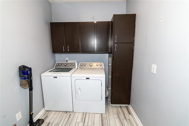 8601 Flint Hill Rd, Douglasville, GA 30135 - laundry area featuring cabinet space, washing machine and clothes dryer, light wood-style floors, and baseboards