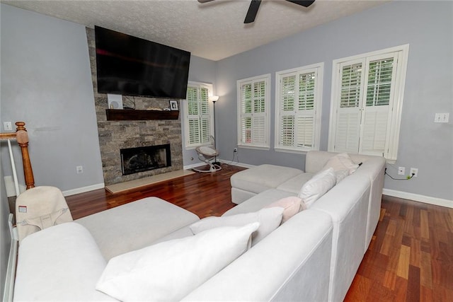 8601 Flint Hill Rd, Douglasville, GA 30135 - living area with wood finished floors, a fireplace, ceiling fan, baseboards, and a textured ceiling