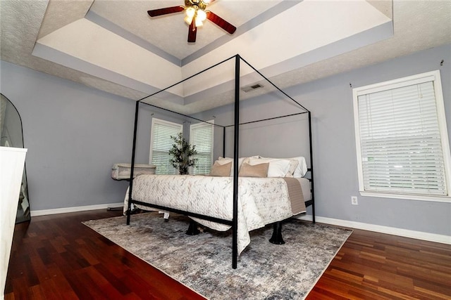 8601 Flint Hill Rd, Douglasville, GA 30135 - bedroom featuring a raised ceiling, wood finished floors, and baseboards