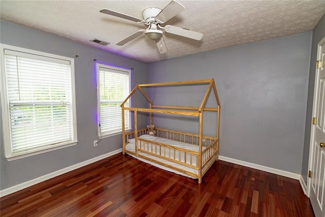 8601 Flint Hill Rd, Douglasville, GA 30135 - bedroom featuring wood finished floors, baseboards, a textured ceiling, and ceiling fan