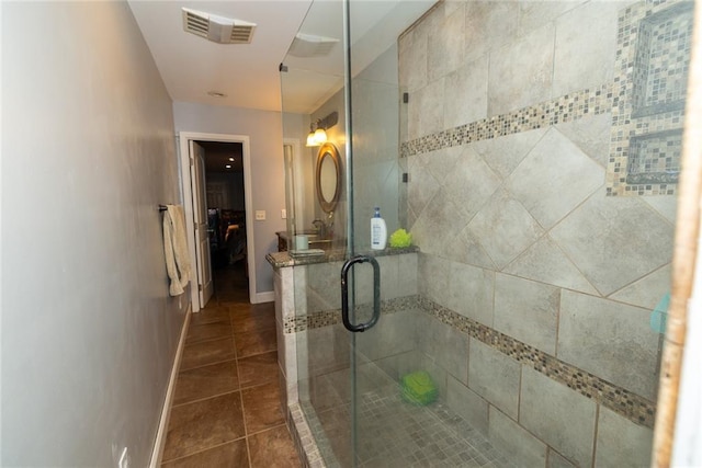 8601 Flint Hill Rd, Douglasville, GA 30135 - ensuite bathroom with a shower stall, tile patterned floors, and baseboards
