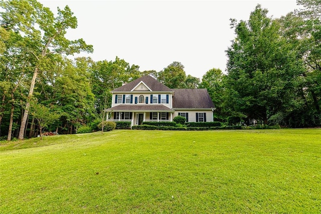 8601 Flint Hill Rd, Douglasville, GA 30135 - colonial-style house featuring a front yard, covered porch, and view of wooded area