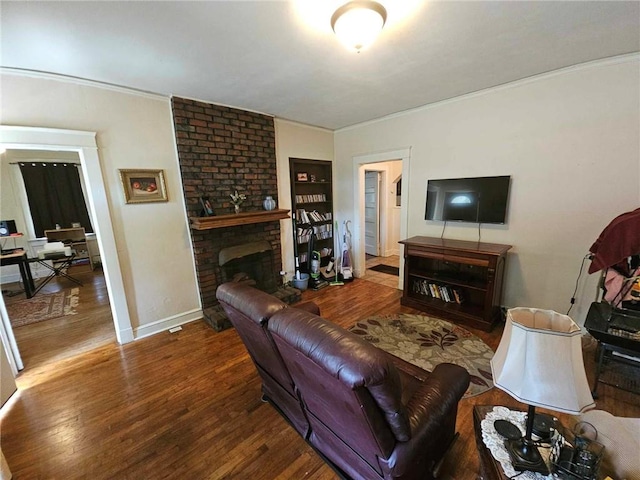 living room with crown molding, dark hardwood / wood-style flooring, and a brick fireplace