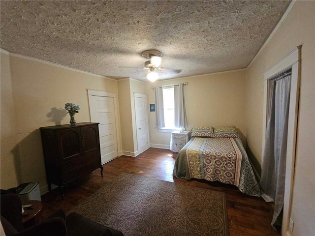 bedroom with a textured ceiling, ornamental molding, dark hardwood / wood-style flooring, and ceiling fan