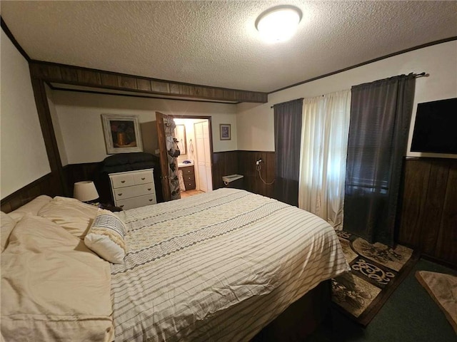 bedroom with a textured ceiling and wooden walls