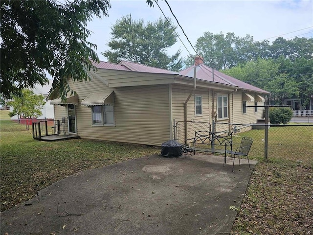 view of side of property with a yard